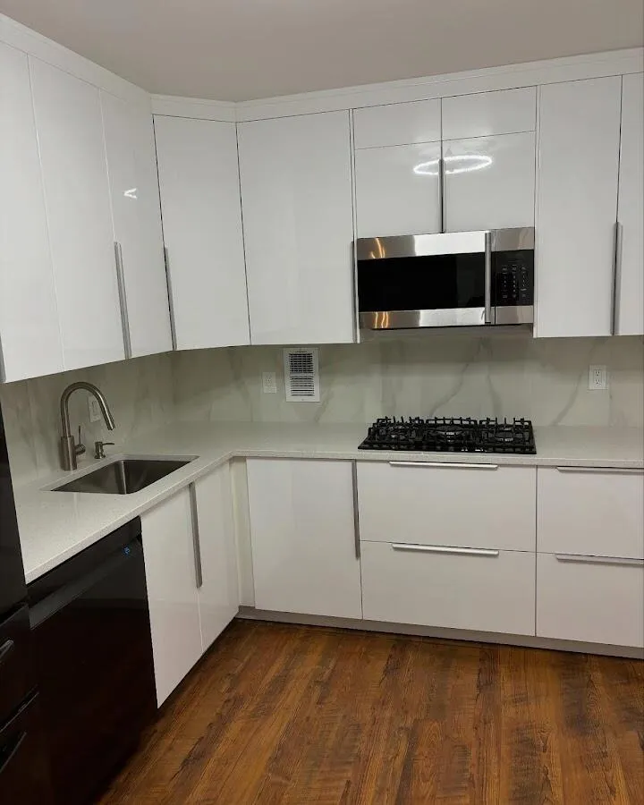 Restored kitchen with white cabinets after water damage in Buda